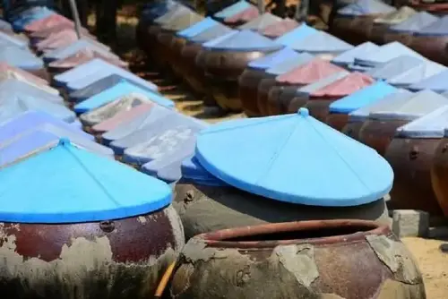 Fermenting fish in large vats to produce delicious bottles of fish sauce.